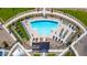 Aerial view of community pool with lounge chairs and shaded picnic tables, perfect for outdoor fun at 3524 N 103Rd Ave, Avondale, AZ 85392