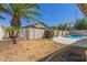 Backyard view with privacy wall, in-ground pool, and landscaping at 3580 E Kesler Ln, Gilbert, AZ 85295