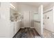 Updated bathroom with dual sinks, wood-look floors, and tiled walk-in shower at 3580 E Kesler Ln, Gilbert, AZ 85295