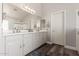 Bright bathroom boasts dual sinks, white cabinetry, modern fixtures, and a tiled walk-in shower at 3580 E Kesler Ln, Gilbert, AZ 85295