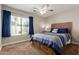 Comfortable bedroom with neutral tones, ceiling fan, and window with pool view at 3580 E Kesler Ln, Gilbert, AZ 85295