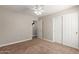 Neutral bedroom featuring carpet, ceiling fan, closet, and ensuite access at 3580 E Kesler Ln, Gilbert, AZ 85295