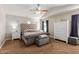 Cozy main bedroom with a comfortable bed, ceiling fan, and ample natural light at 3580 E Kesler Ln, Gilbert, AZ 85295