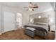 Serene main bedroom with a comfortable bed, ceiling fan, and ensuite bathroom at 3580 E Kesler Ln, Gilbert, AZ 85295