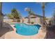 Backyard inground pool with palm trees, landscaping, and privacy at 3580 E Kesler Ln, Gilbert, AZ 85295