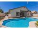 Sparkling private pool surrounded by patio and the home's back exterior at 3580 E Kesler Ln, Gilbert, AZ 85295