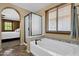 A well-appointed bathroom offering a tub and separate shower with a glass enclosure at 3828 S Verbena Ave, Gilbert, AZ 85297