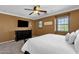 This bedroom features a ceiling fan, neutral carpet, and natural light at 3828 S Verbena Ave, Gilbert, AZ 85297