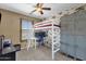 Cozy bedroom featuring airplane wallpaper, a loft bed, and grey metal lockers at 3828 S Verbena Ave, Gilbert, AZ 85297