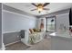 A cozy bedroom showcases a small bed, neutral carpet and paint, and natural light from the window at 3828 S Verbena Ave, Gilbert, AZ 85297