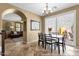 Bright dining room with view to the living room and patio, featuring tile floors at 3828 S Verbena Ave, Gilbert, AZ 85297
