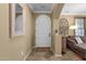 Cozy entryway showcasing tile flooring, a mirror and a white arched door at 3828 S Verbena Ave, Gilbert, AZ 85297