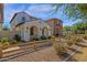 Beautiful two-story home featuring a light-colored stucco exterior with a charming arched entryway at 3828 S Verbena Ave, Gilbert, AZ 85297