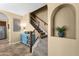 Hallway featuring a decorative cabinet, staircase, and an arched display niche at 3828 S Verbena Ave, Gilbert, AZ 85297