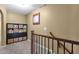 Upstairs hallway featuring a convenient storage unit, and natural light from a window at 3828 S Verbena Ave, Gilbert, AZ 85297
