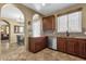 Kitchen featuring dark wood cabinets, granite counters, and modern appliances at 3828 S Verbena Ave, Gilbert, AZ 85297
