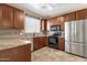 Well-lit kitchen with granite countertops and stainless steel appliances at 3828 S Verbena Ave, Gilbert, AZ 85297