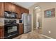 Kitchen featuring stainless steel refrigerator and black oven at 3828 S Verbena Ave, Gilbert, AZ 85297
