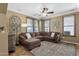 Spacious living room featuring a comfortable sectional sofa and warm color scheme at 3828 S Verbena Ave, Gilbert, AZ 85297