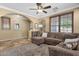 Comfortable living room with a ceiling fan, tile flooring, and natural light from the window at 3828 S Verbena Ave, Gilbert, AZ 85297