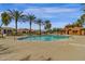 Community pool with a cabana and many palm trees at 3828 S Verbena Ave, Gilbert, AZ 85297