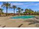Large community pool surrounded by palm trees, lounge chairs, and well-maintained landscaping at 3828 S Verbena Ave, Gilbert, AZ 85297