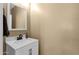 Powder room featuring a white vanity with a stone countertop and modern faucet at 3828 S Verbena Ave, Gilbert, AZ 85297