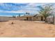 Wide backyard featuring a covered patio and full perimeter fencing for privacy at 4106 W Mission Ln, Phoenix, AZ 85051