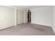 Empty bedroom features neutral carpet, a window, and double closet doors at 4106 W Mission Ln, Phoenix, AZ 85051