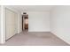 Empty bedroom features neutral carpet, a window, and closet space at 4106 W Mission Ln, Phoenix, AZ 85051