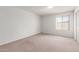 Empty bedroom features neutral carpet, a window, and closet space at 4106 W Mission Ln, Phoenix, AZ 85051