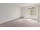 Neutral bedroom featuring carpeted floors and a large window with horizontal blinds at 4106 W Mission Ln, Phoenix, AZ 85051