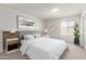 Staged bedroom features a large bed, side tables, and a neutral color scheme at 4106 W Mission Ln, Phoenix, AZ 85051