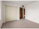 Bedroom featuring a large closet for ample storage and neutral carpet at 4106 W Mission Ln, Phoenix, AZ 85051