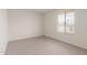 Empty bedroom with a window letting in natural light, complemented by neutral carpet at 4106 W Mission Ln, Phoenix, AZ 85051