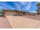 Single-story home featuring a two-car garage with a concrete driveway and desert landscaping at 4106 W Mission Ln, Phoenix, AZ 85051