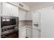 Classic kitchen design with white cabinets and a built in oven and microwave combo at 4106 W Mission Ln, Phoenix, AZ 85051