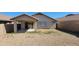 View of backyard featuring gravel and a covered patio accessible through sliding glass doors at 419 W Harwell Rd, Phoenix, AZ 85041
