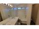 Bright bathroom featuring a double sink vanity with marble countertop and shower-tub combination at 419 W Harwell Rd, Phoenix, AZ 85041