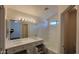 Bright bathroom featuring a double sink vanity with marble countertop and shower-tub combination at 419 W Harwell Rd, Phoenix, AZ 85041