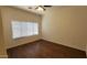 Bright bedroom with hardwood floors, a ceiling fan, and large windows offering plenty of natural light at 419 W Harwell Rd, Phoenix, AZ 85041