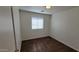 Comfortable bedroom featuring wood floors, neutral walls, and a standard ceiling light fixture at 419 W Harwell Rd, Phoenix, AZ 85041