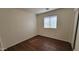 Cozy bedroom featuring wood floors, neutral walls, and a window providing natural light at 419 W Harwell Rd, Phoenix, AZ 85041