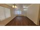 Bright living room featuring wood floors, neutral walls, and large windows with ample natural light at 419 W Harwell Rd, Phoenix, AZ 85041