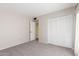 A neutral bedroom has carpet flooring, closet, and doorway at 4233 W Michigan Ave, Glendale, AZ 85308
