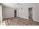 A neutral bedroom features a ceiling fan, wood look tile flooring, and ensuite bathroom access at 4233 W Michigan Ave, Glendale, AZ 85308