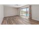 A bright bedroom features a neutral color scheme, wood look tile flooring, and a backyard view at 4233 W Michigan Ave, Glendale, AZ 85308