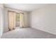 A bright bedroom features carpet flooring and a window at 4233 W Michigan Ave, Glendale, AZ 85308