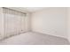 A neutral bedroom has carpet flooring and a large window at 4233 W Michigan Ave, Glendale, AZ 85308
