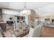 Open-concept dining area with modern chandelier, connecting kitchen and living spaces at 4233 W Michigan Ave, Glendale, AZ 85308
